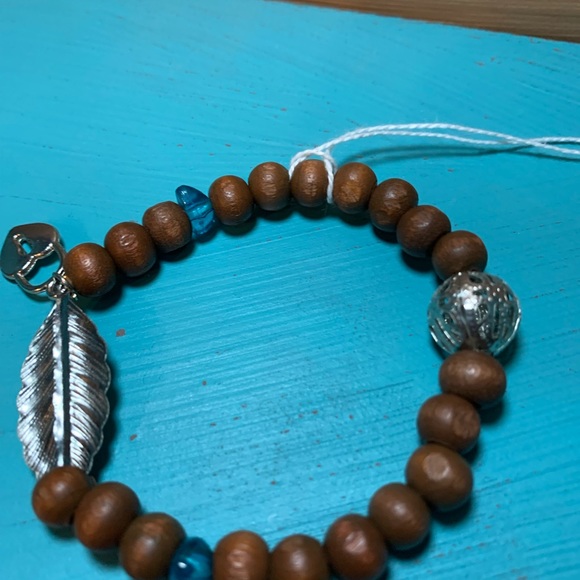 Wood bead bracelet with feather and heart lock. Stretchy one size boho vibe. - Picture 7 of 7